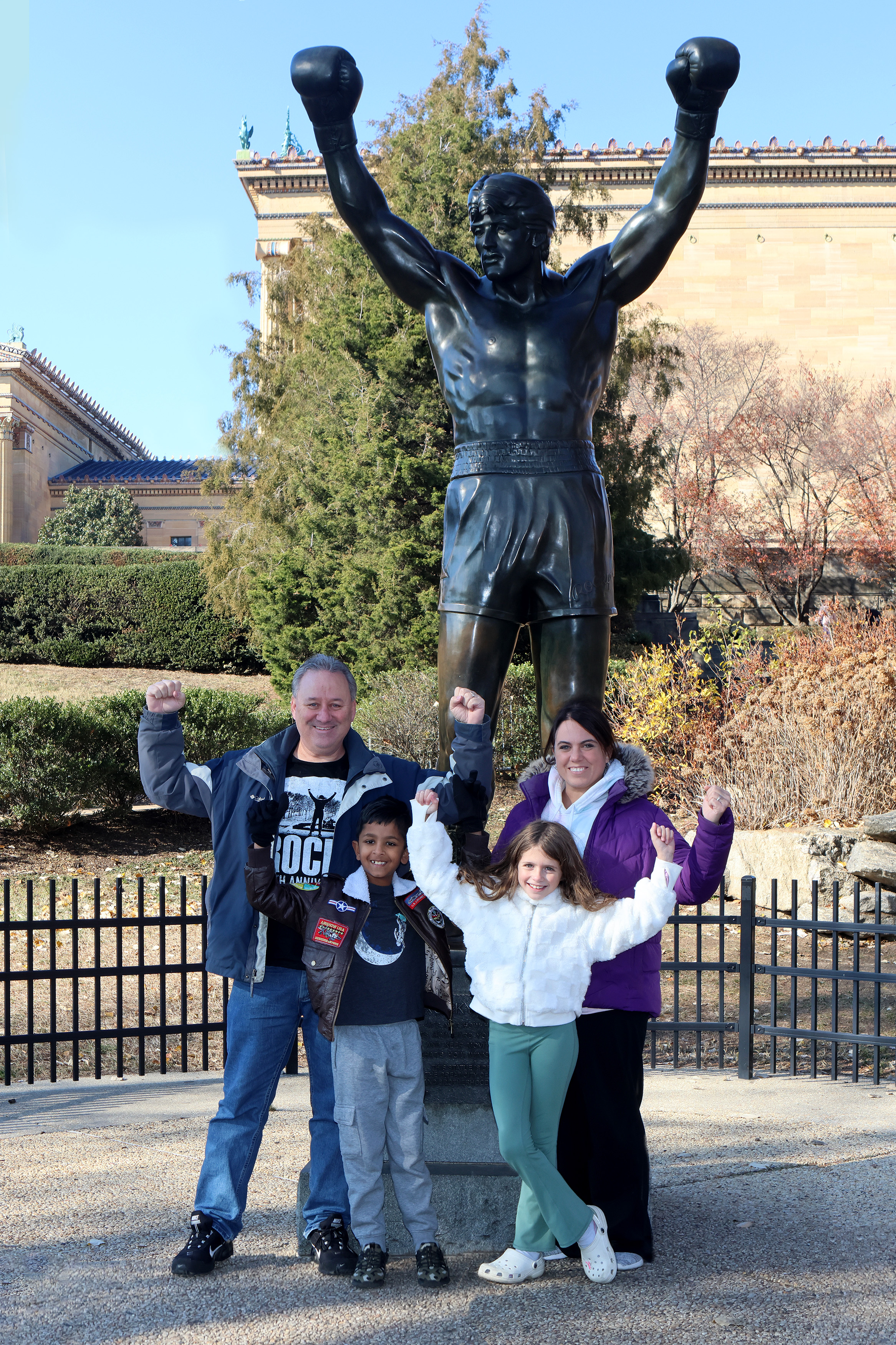 Our family at the Rocky Statue at the base of the Rocky Steps in 2024.