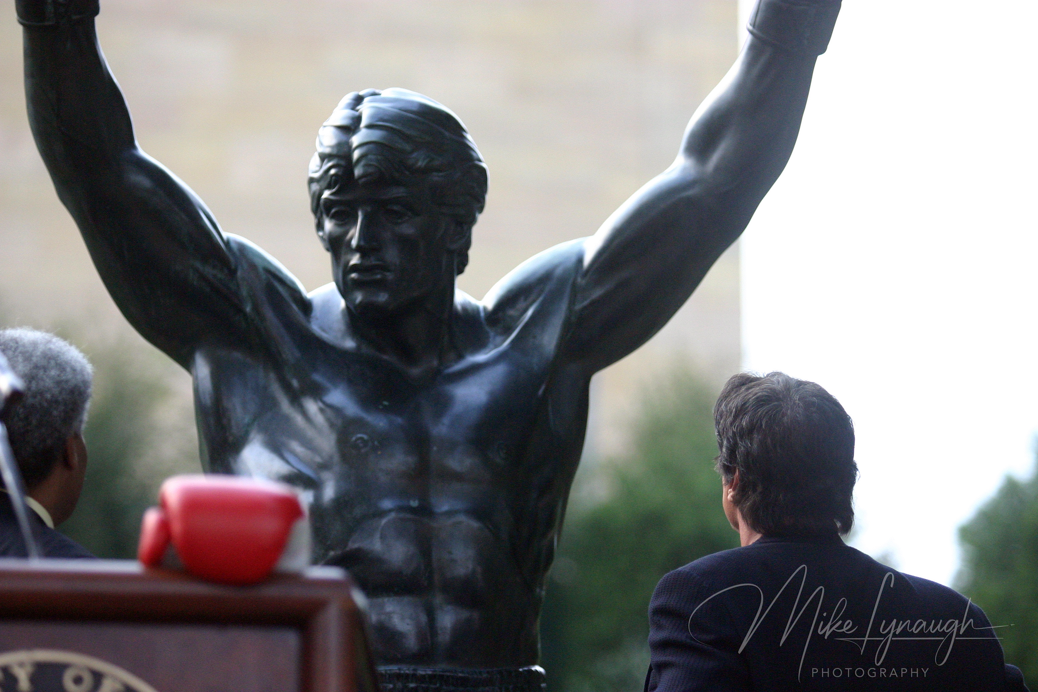 Sylvester Stallone enjoys the moment with the Rocky Statue following his speech at the rededication of the statue at the base of the Rocky Steps at the Philadelphia Museum of Art.