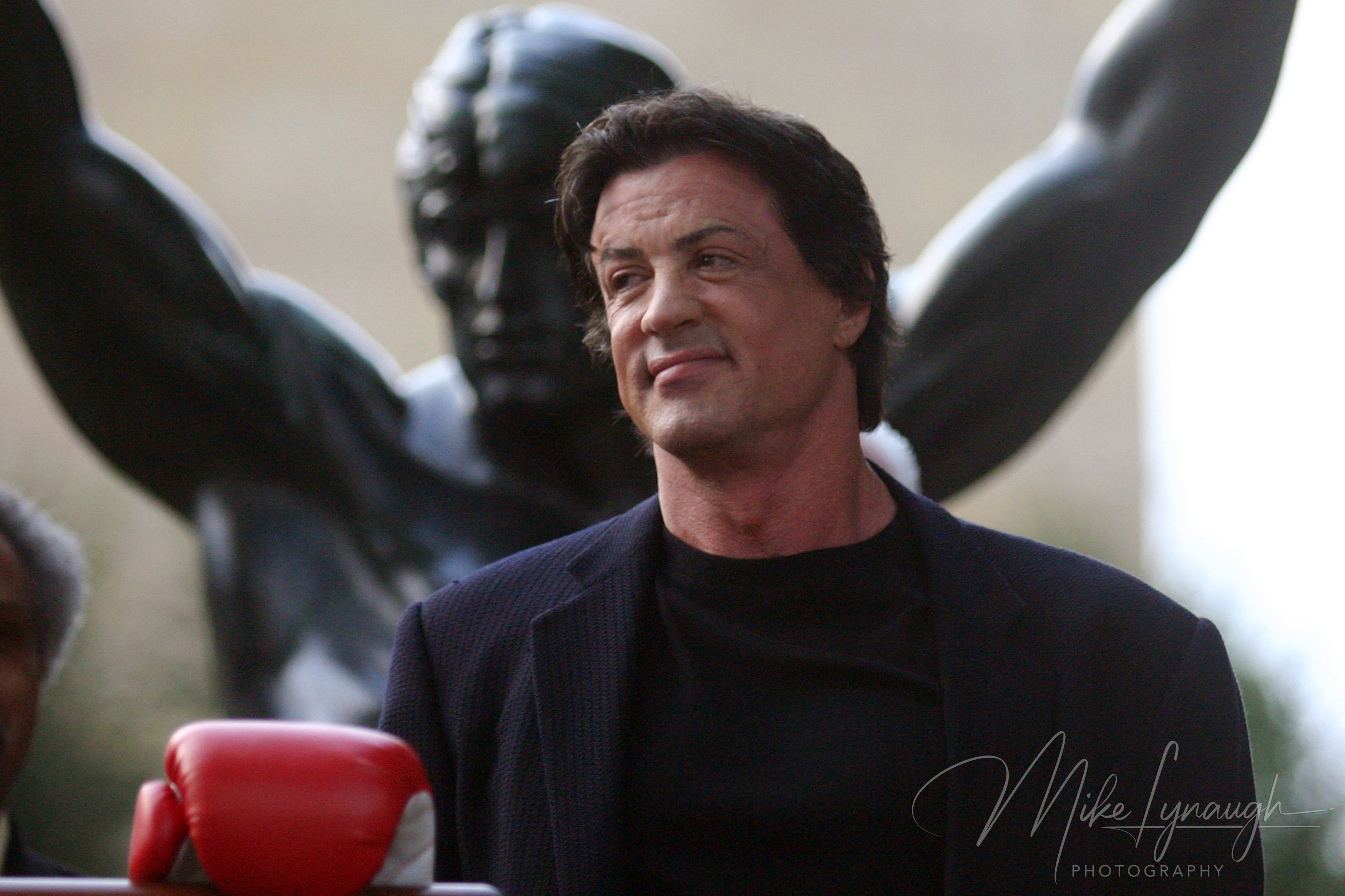 Sylvester Stallone poses with the Rocky Statue during the rededication of the statue at the base of the Rocky Steps at the Philadelphia Museum of Art.