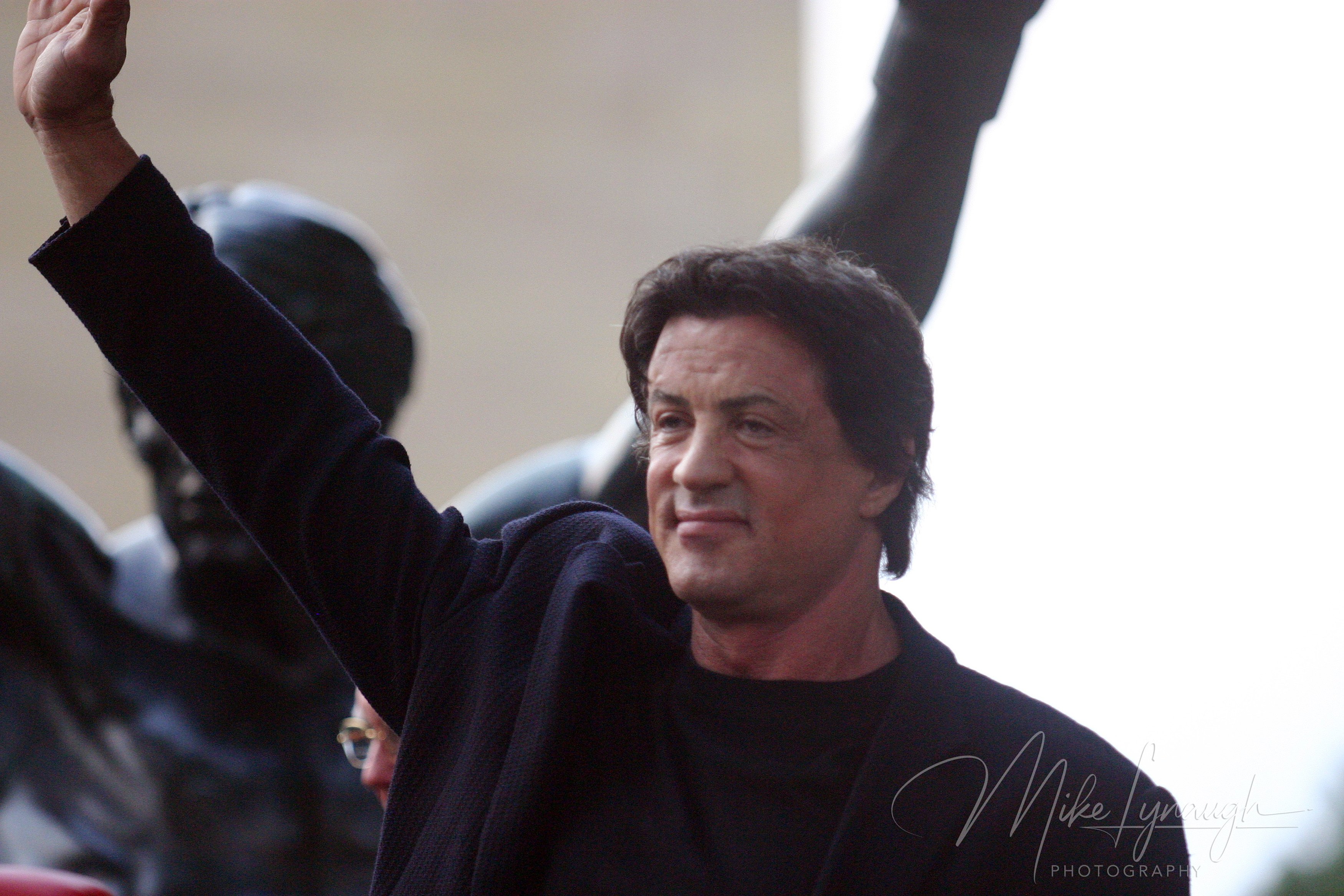 Sylvester Stallone poses with the Rocky Statue during the rededication of the statue at the base of the Rocky Steps at the Philadelphia Museum of Art.